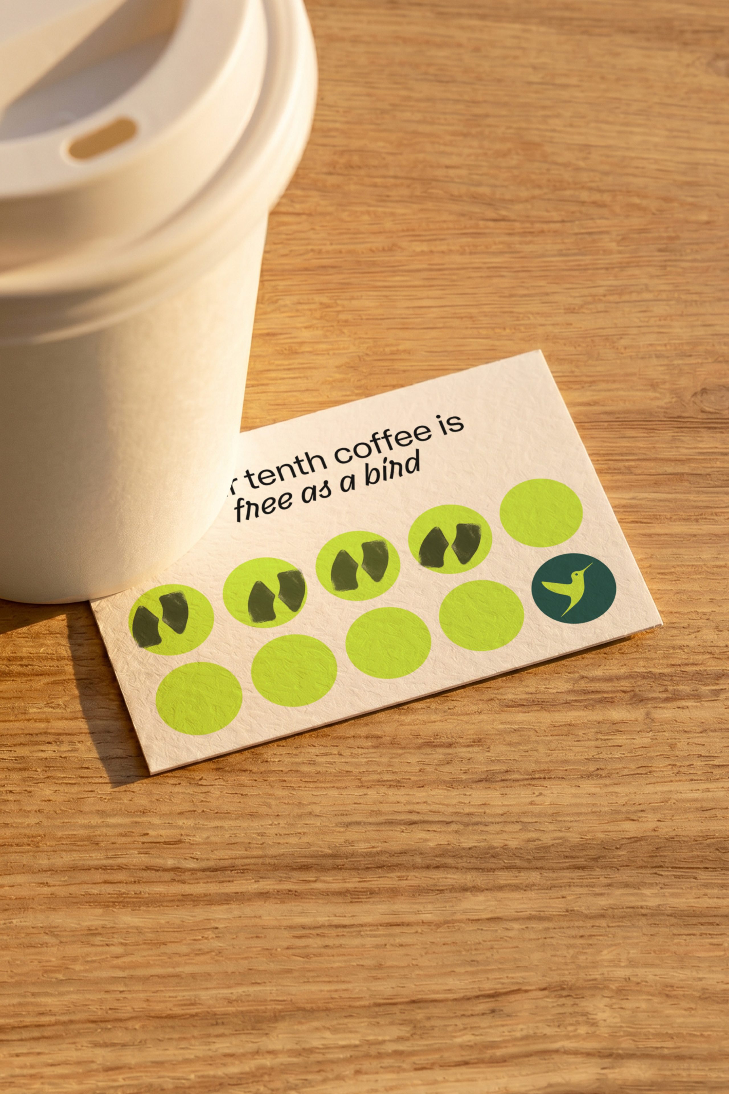 Loyalty card reading "tenth coffee is free as a bird" with hummingbird logo