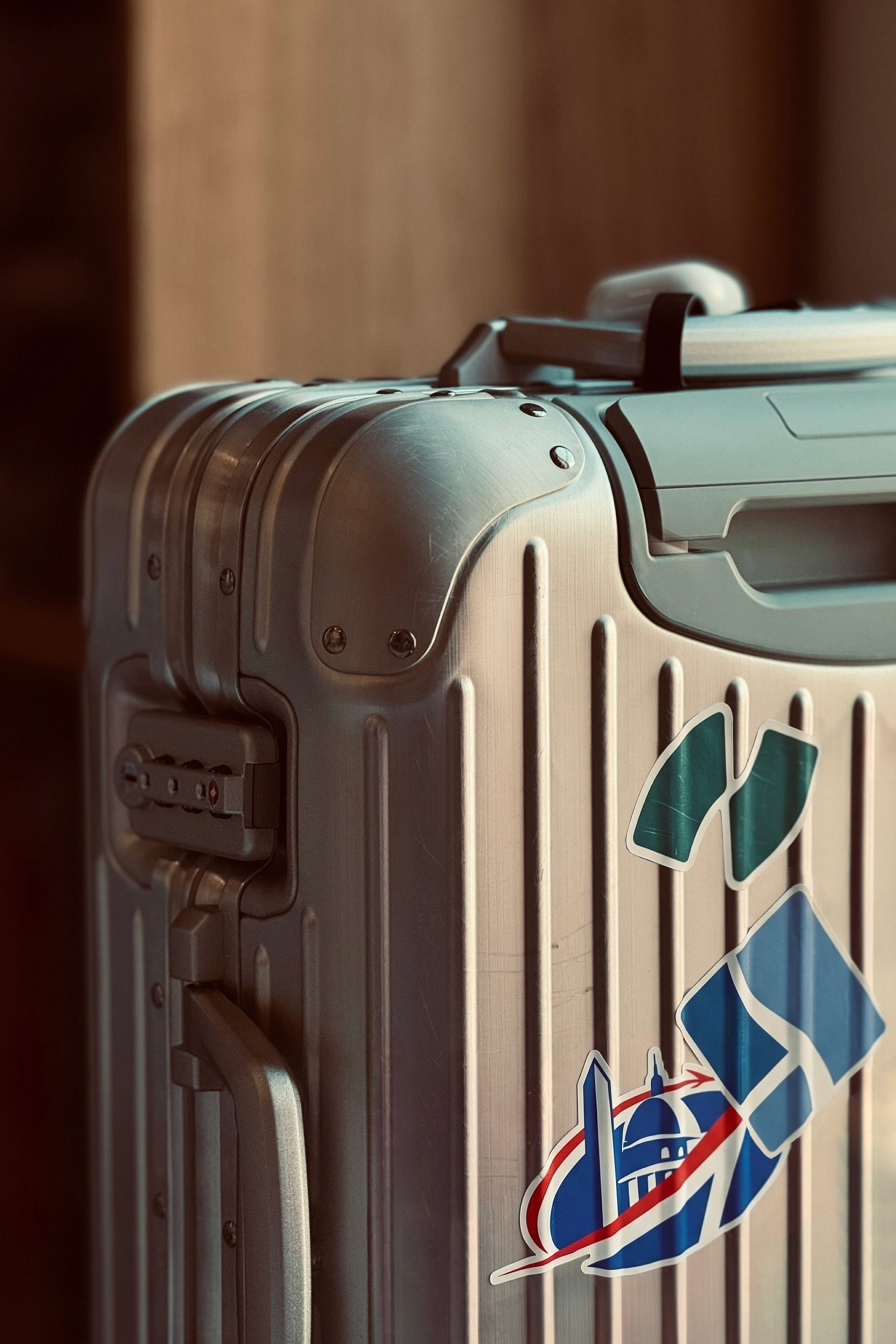 Aluminium suitcase with National Landing BID logo stickers attached