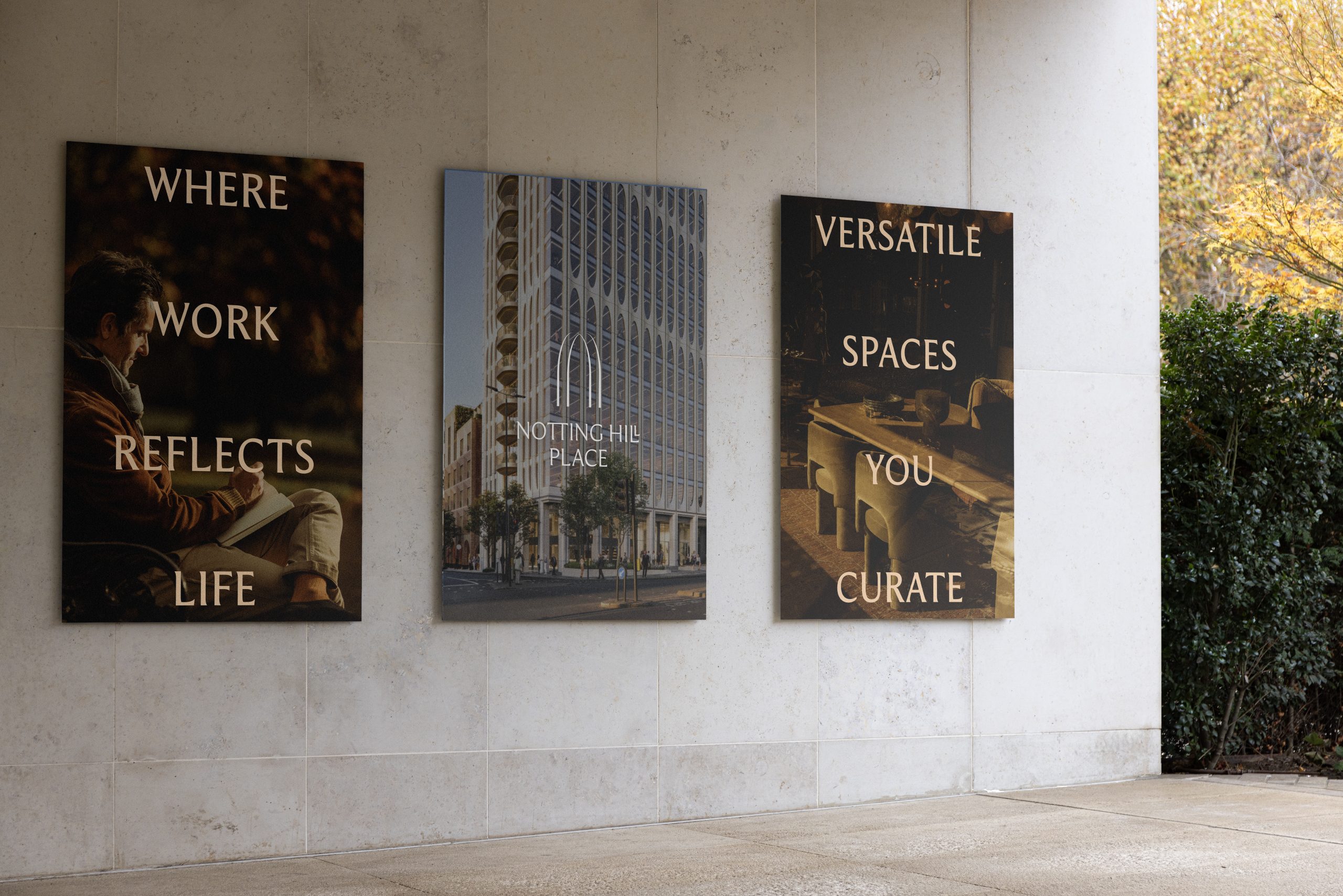 Three Notting Hill Place posters on a stone wall reading 'Where Work Reflects Life' and 'Versatile Spaces You Curate' with a building render