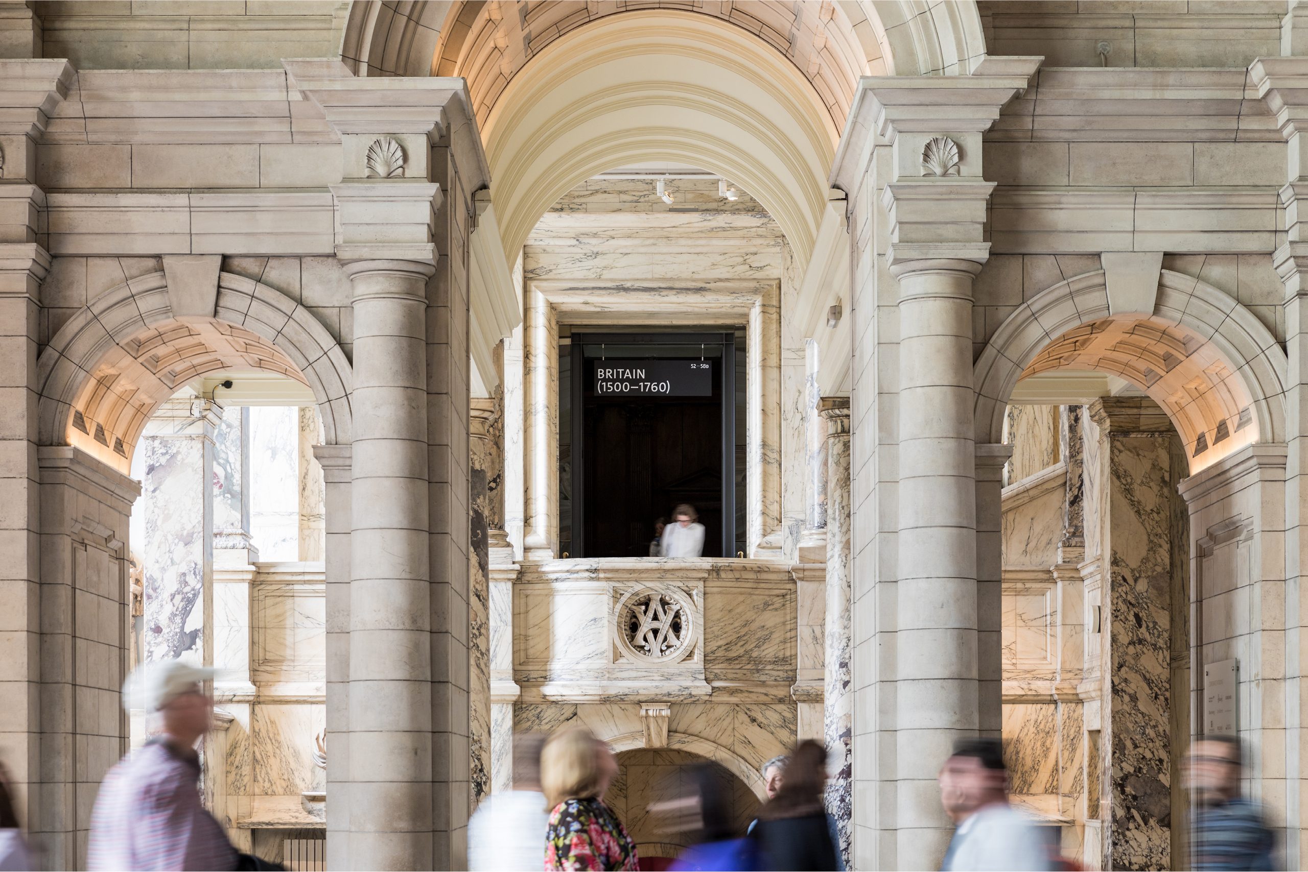 V&A's marble-columned hall, with a Britain (1500–1760) gallery sign visible ahead
